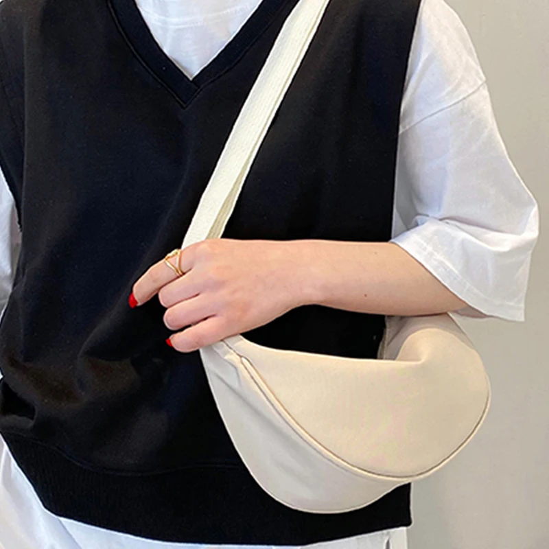 sac pour femme – un sac en nylon de forme ronde avec une bandoulière, adapté aux voyages, à l'école ou au shopping.