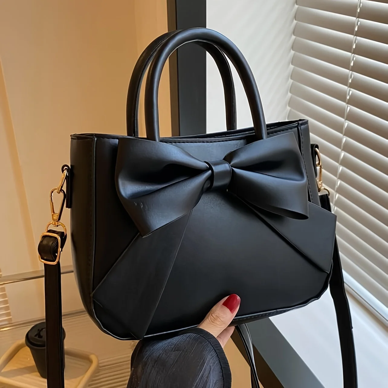 sac à main élégant à nœud noir avec quincaillerie dorée, sangle amovible. polyvalent pour un usage quotidien et les événements formels. mode indispensable! boutique maintenant!