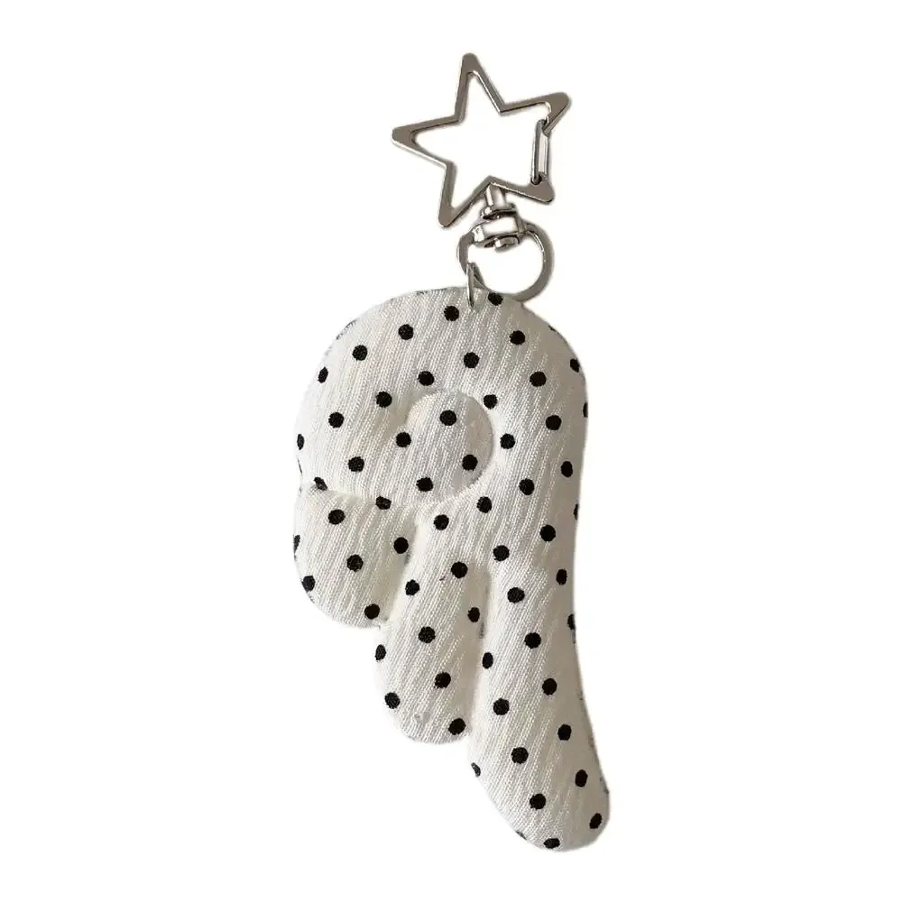 cadenas serrure tsa pochette cuir noir détails métal argent ailes tissu blanc noir pois coeur étoile metallique chaînes