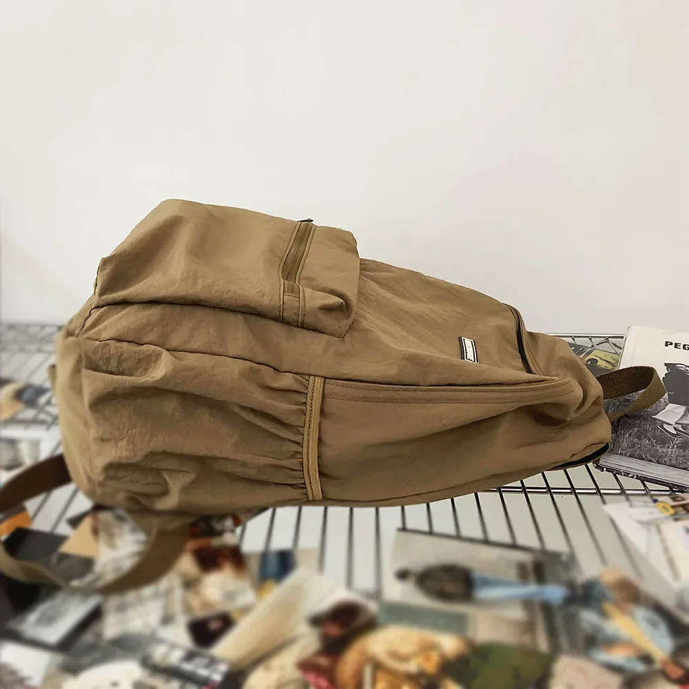 sac dos nylon beige clair pliable grande capacité bandoulière arquée poche intérieure zippée usage voyage décontracté
