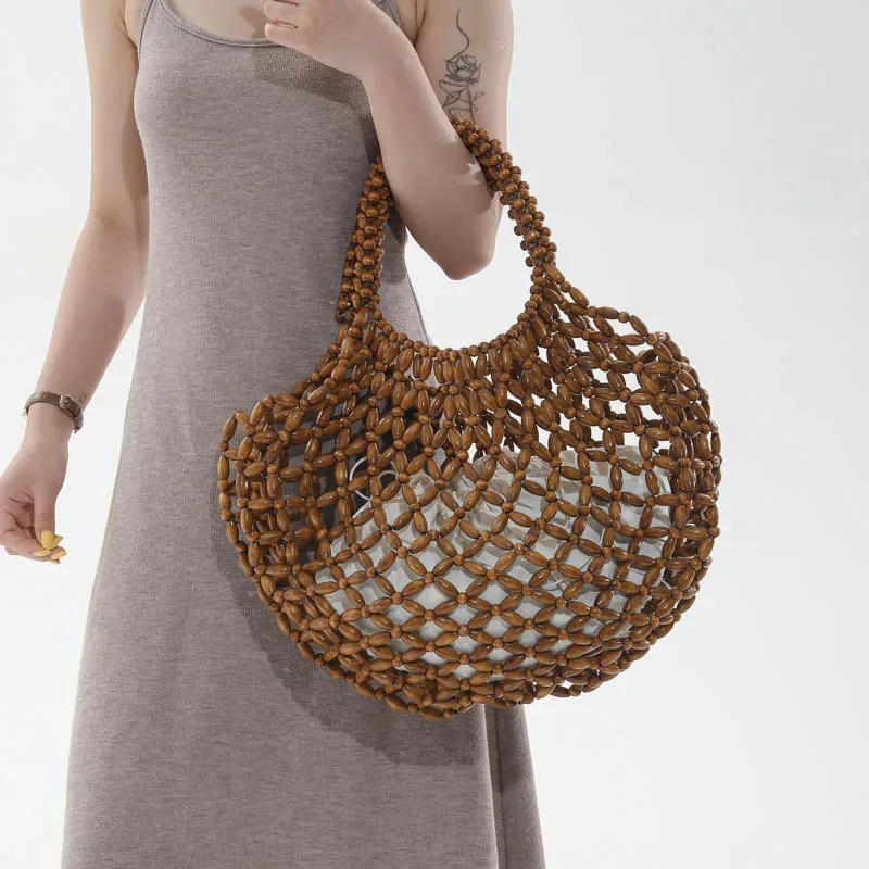 sac à main féminin fait main en perles, sac de plage tissé pour femmes, design exquis, sac seau creux en perles de bois, sac à bandoulière.
