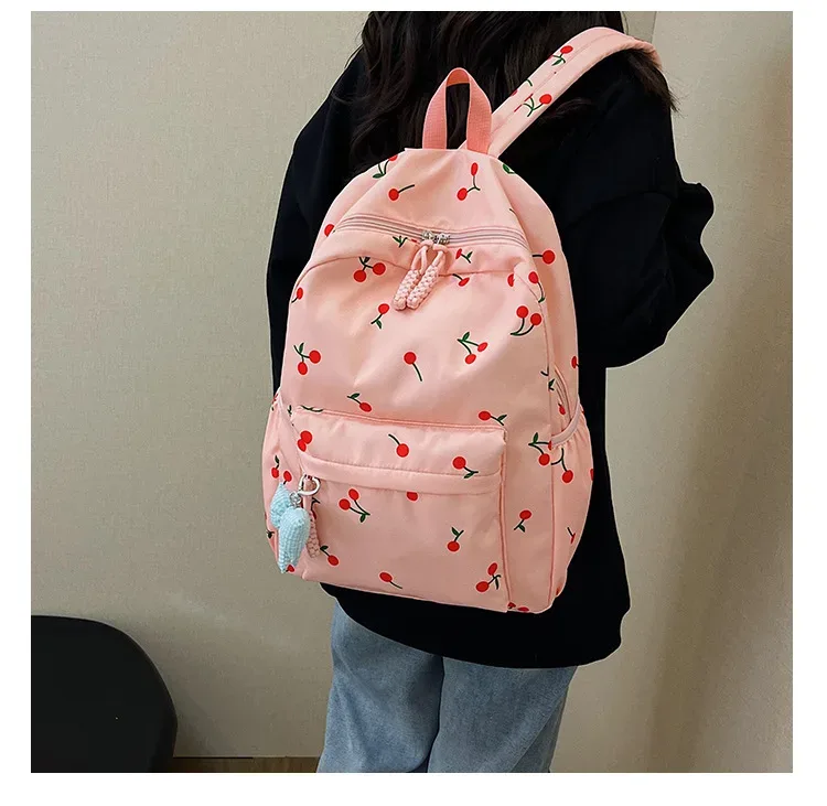 sac dos polyester imprimé cerises rouge fond rose blanc noir pochette assortie 20 35 litres unisexe voyage école
