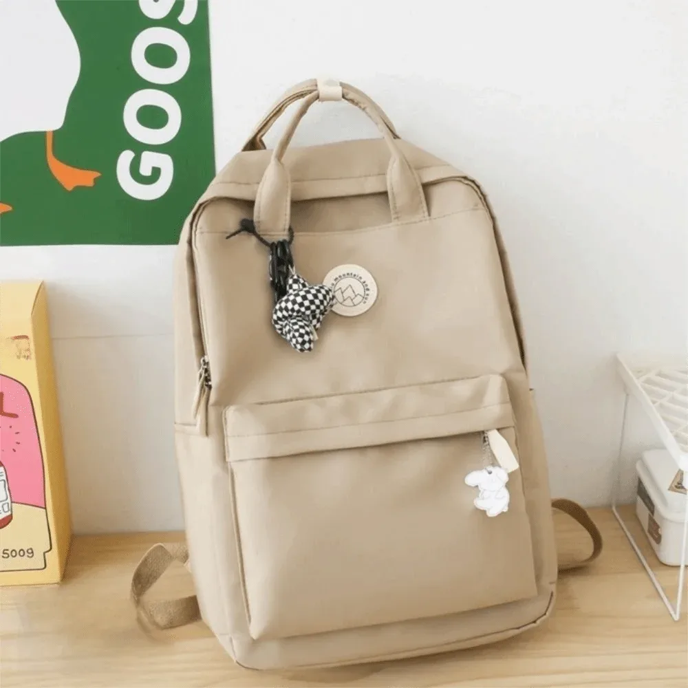 sac à dos imperméable pour femmes, en nylon, couleur unie, sac à dos de voyage ergonomique, grande capacité, sac pour ordinateur portable et livres, idéal pour les voyages d'affaires.