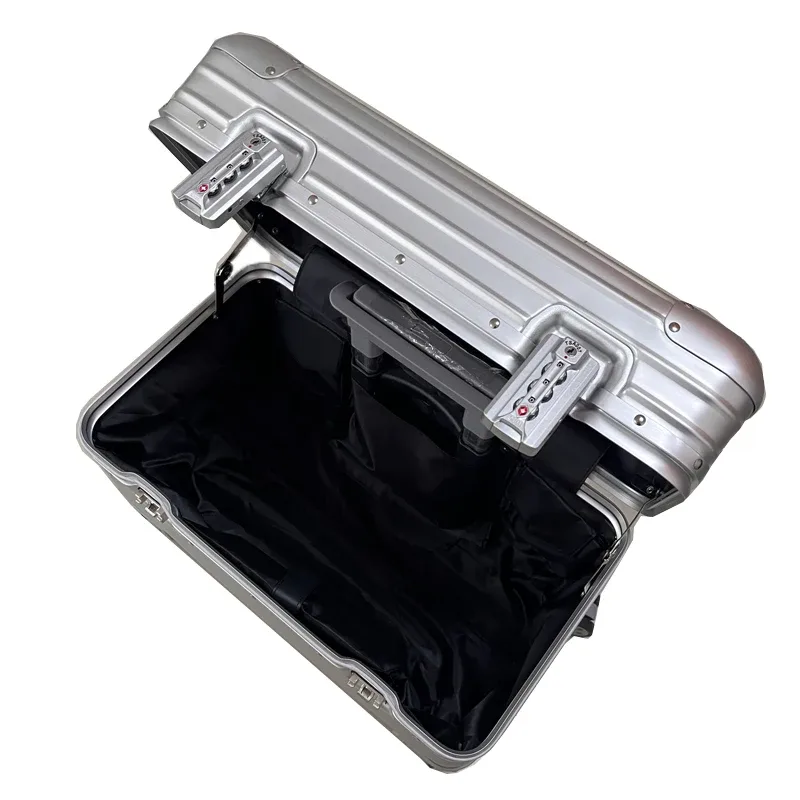 valise aluminium argent doré beige toupie roulettes poignée plaque centrale gris voyage business week-end