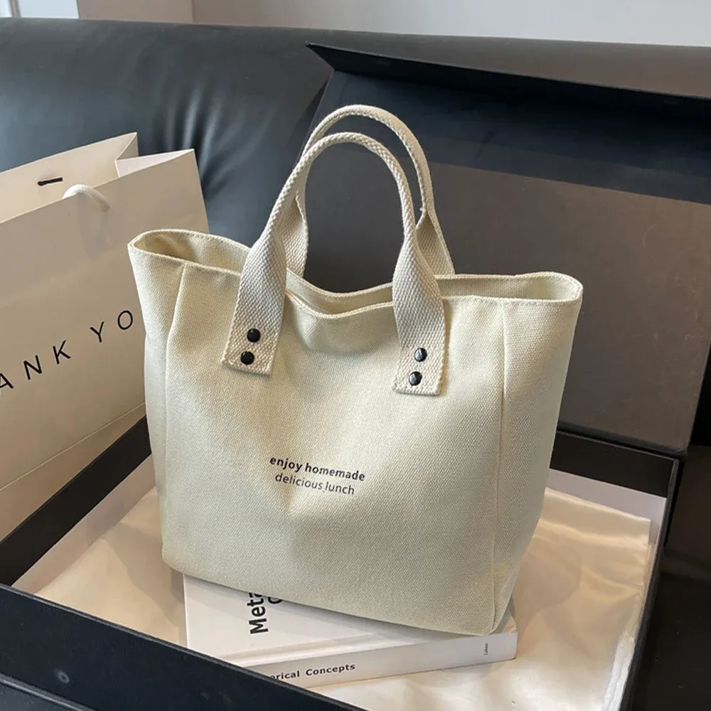 sac fourre-tout décontracté en toile avec pendentif cloche et fermeture éclair ; ce sac fourre-tout élégant et durable est parfait pour l'école et le travail