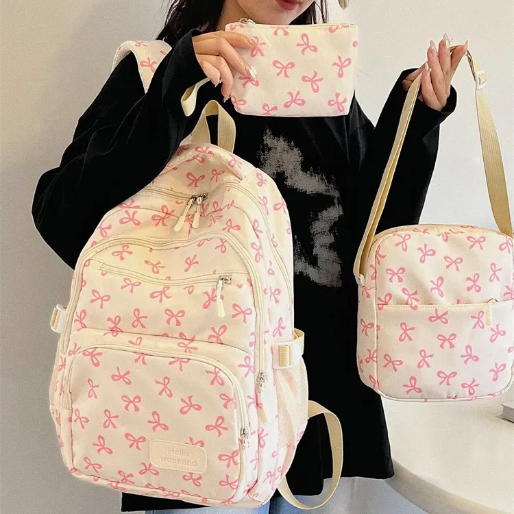 sac dos polyester motifs nœuds rose clair blanc noir bandoulière poignées latérales voyage scolaire femmes