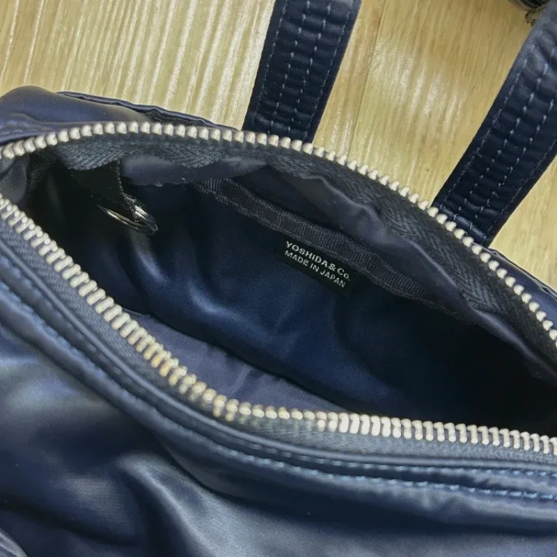 sac à main porter howl mini 2way pour hommes et femmes, petit sac bandoulière léger, style streetwear, mode quotidienne, portable pour les trajets quotidiens et les voyages.