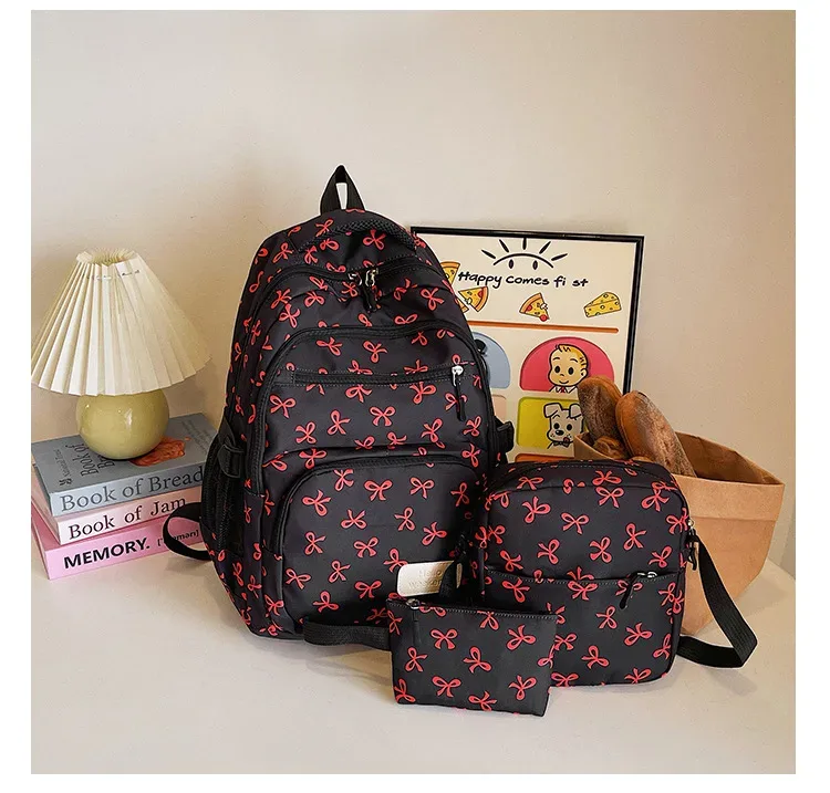 sac dos polyester motifs nœuds rose clair blanc noir bandoulière poignées latérales voyage scolaire femmes