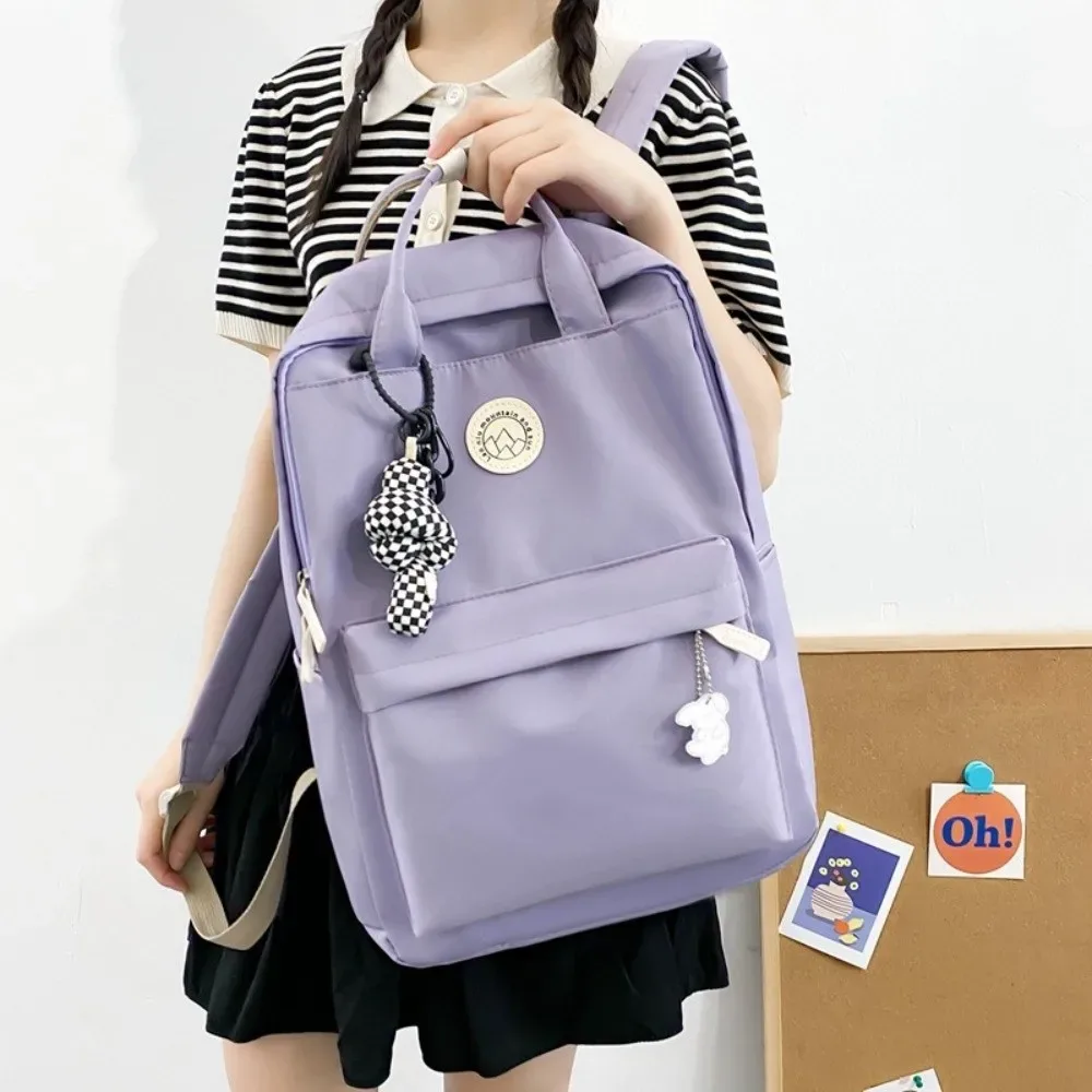 sac à dos imperméable pour femmes, en nylon, couleur unie, sac à dos de voyage ergonomique, grande capacité, sac pour ordinateur portable et livres, idéal pour les voyages d'affaires.