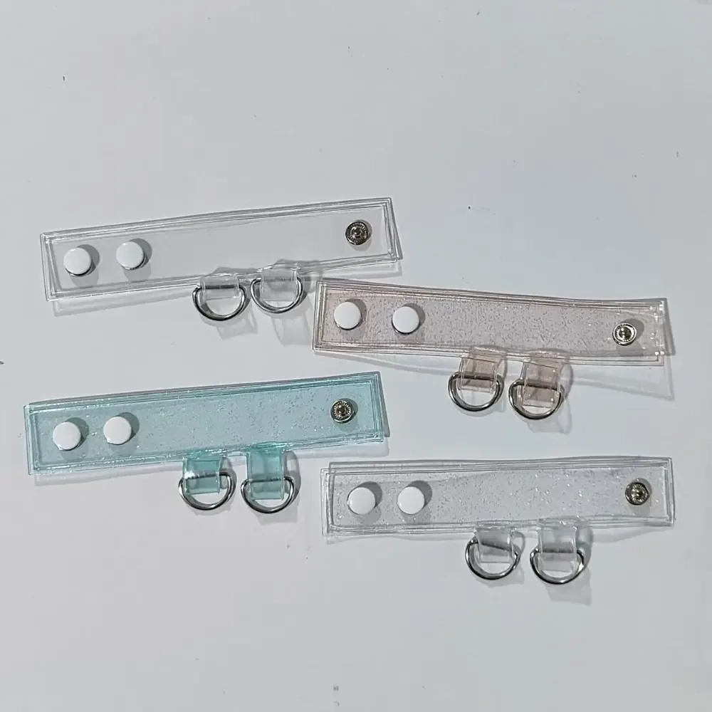 clip fixation sangle sac transparent anneaux métalliques boule centrale extension accessoires voyage polyvalent durables
