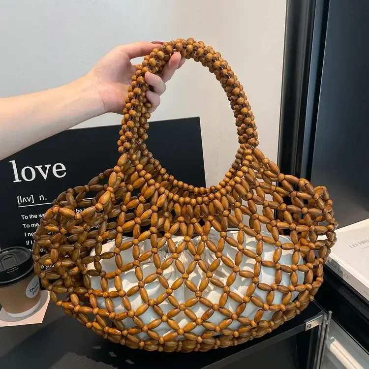 sac à main féminin fait main en perles, sac de plage tissé pour femmes, design exquis, sac seau creux en perles de bois, sac à bandoulière.