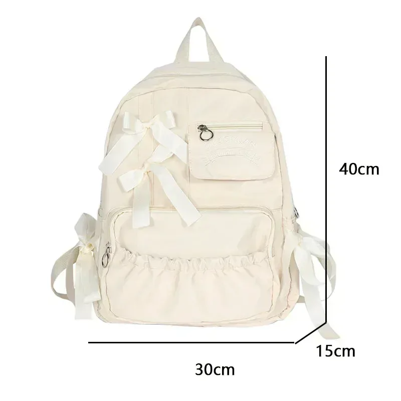 sac dos nylon beige poche ouverte fermeture éclair style preppy arc décoration usage voyage école adolescente femmes