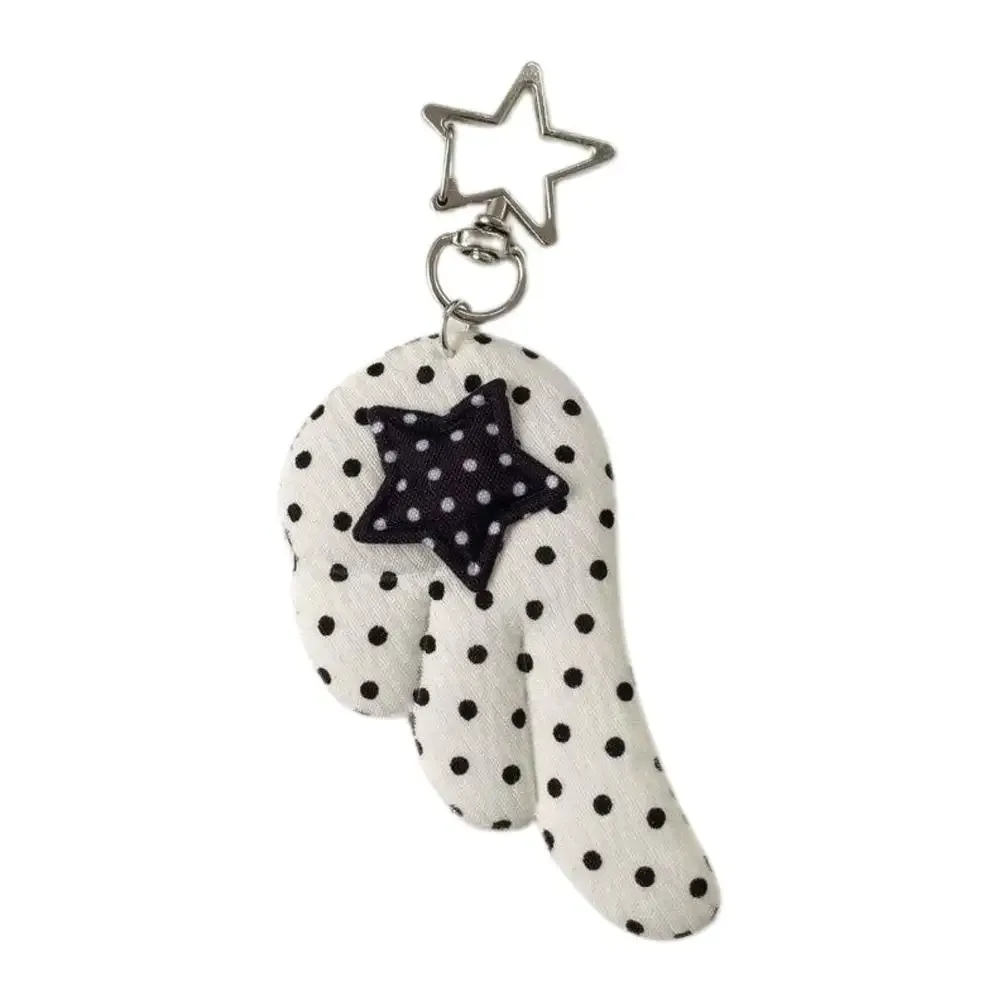 cadenas serrure tsa pochette cuir noir détails métal argent ailes tissu blanc noir pois coeur étoile metallique chaînes