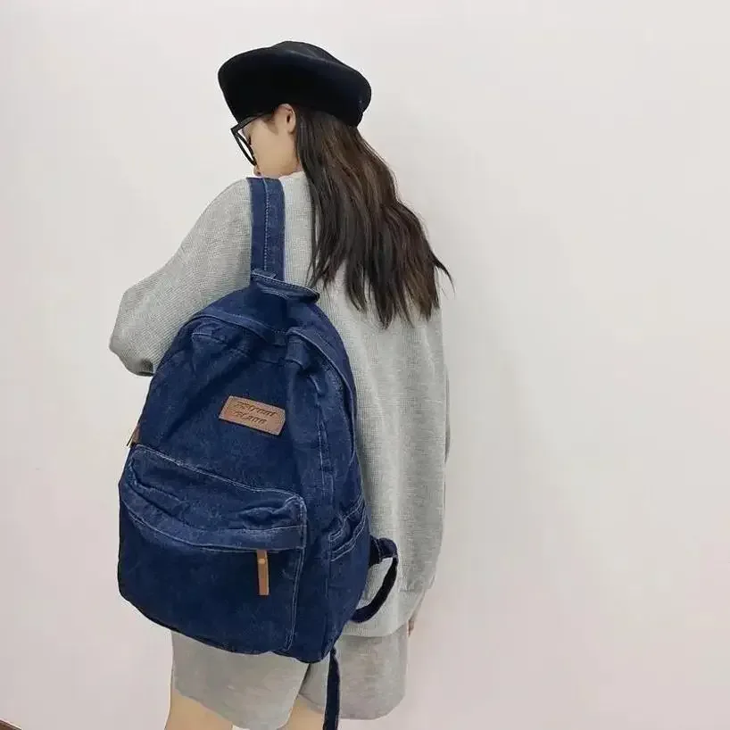 sac dos jean bleu denim poignée supérieure fermeture éclair compartiment intérieur usage étudiant voyage