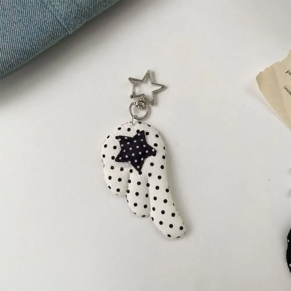 cadenas serrure tsa pochette cuir noir détails métal argent ailes tissu blanc noir pois coeur étoile metallique chaînes