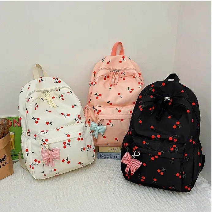sac dos polyester imprimé cerises rouge fond rose blanc noir pochette assortie 20 35 litres unisexe voyage école