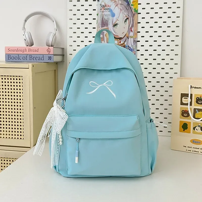 sac à dos portable brodé avec nœud pour filles, sac d'école en nylon de couleur unie pour étudiants, sac à dos de voyage léger de grande capacité pour femmes