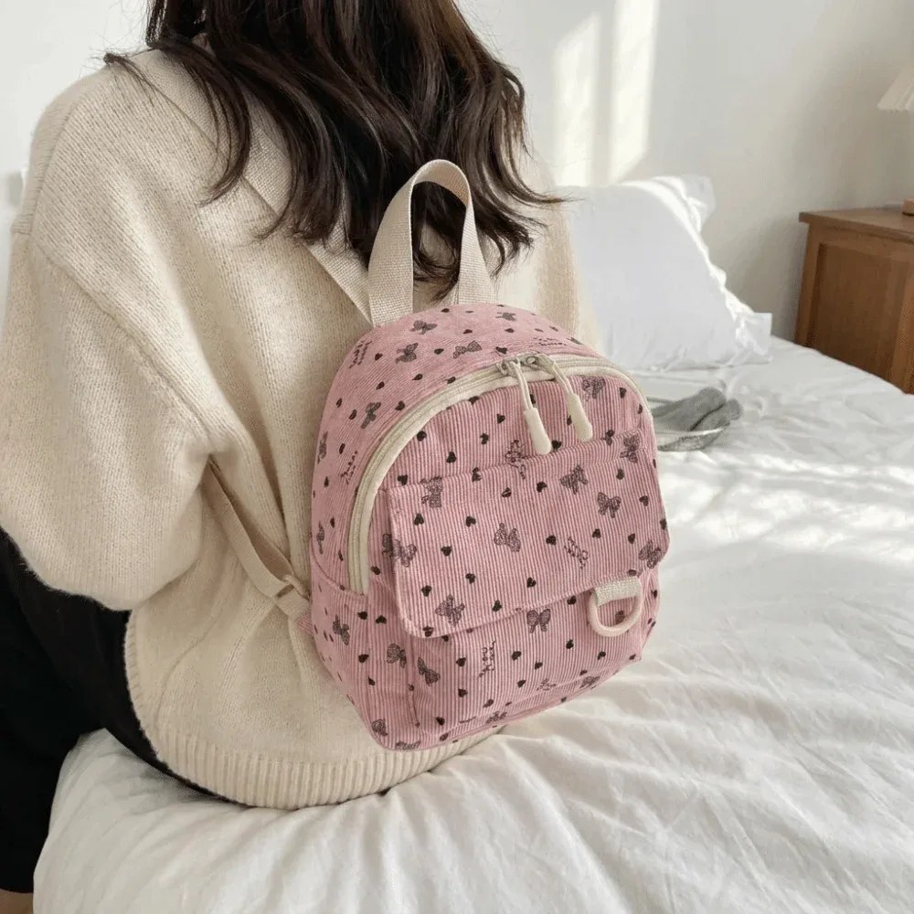Mini sac à dos en velours côtelé léger avec imprimé cœur et nœud, sac à bandoulière multi-compartiments à ouverture zippée, sac à dos quotidien