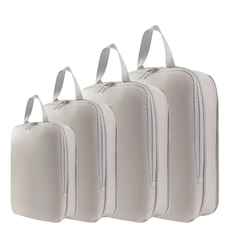 organisateur voyage polyester blanc bandes grises format rectangulaire poignées grises compression vêtements articles toilette rangement valise
