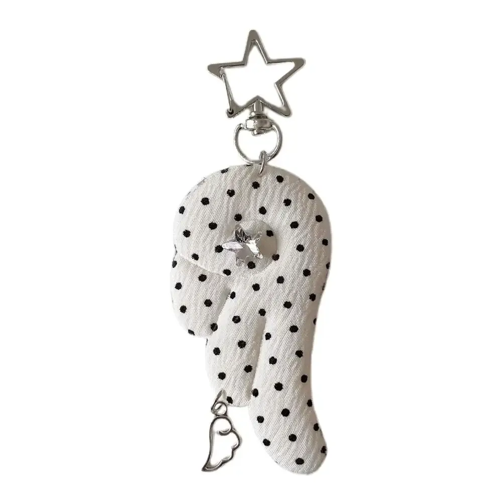 cadenas serrure tsa pochette cuir noir détails métal argent ailes tissu blanc noir pois coeur étoile metallique chaînes