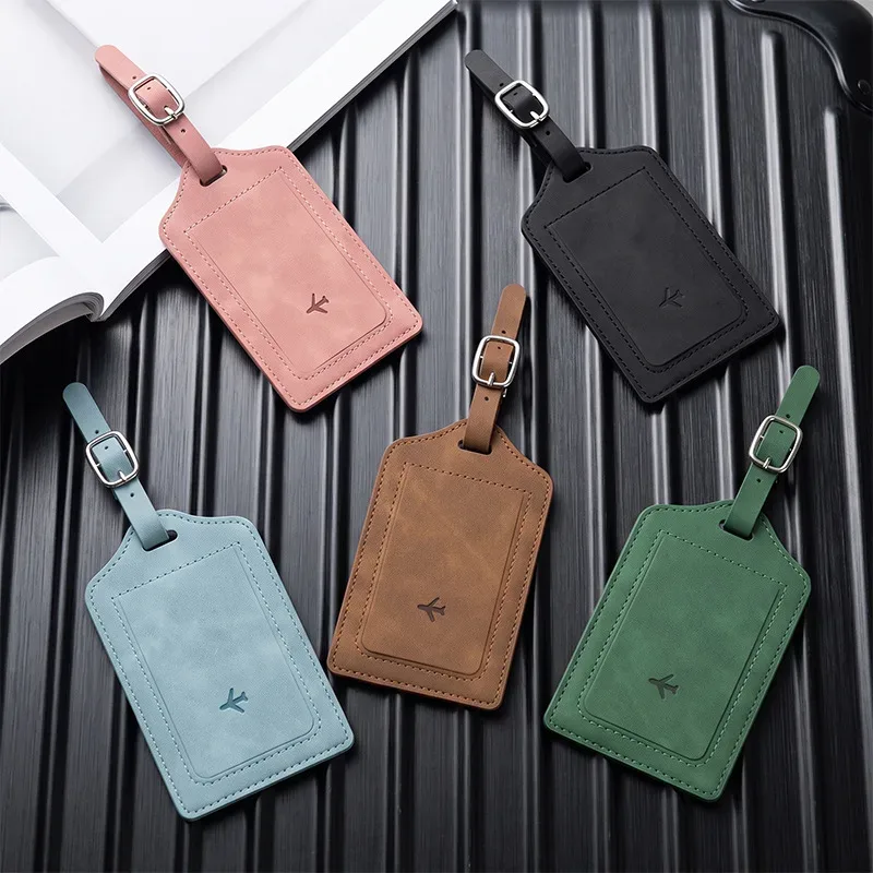 étiquette bagage cuir simili bleu noir rose voyage identification valise nom adresse pochette contact symbole avion reliefs