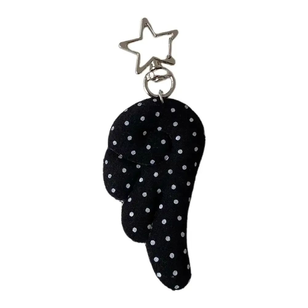 cadenas serrure tsa pochette cuir noir détails métal argent ailes tissu blanc noir pois coeur étoile metallique chaînes