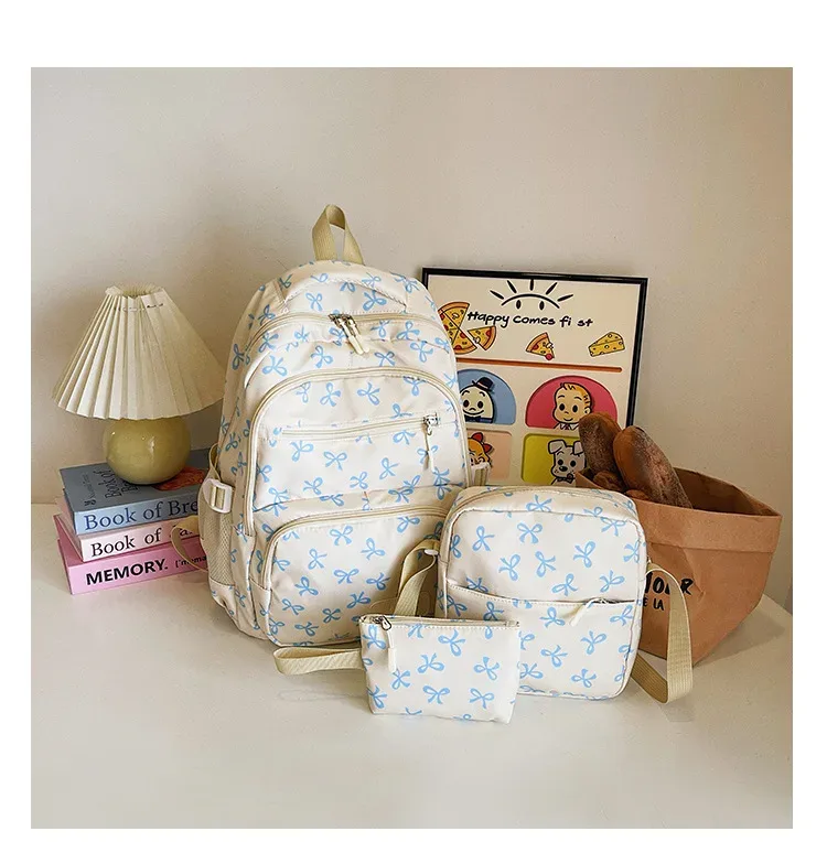 sac dos polyester motifs nœuds rose clair blanc noir bandoulière poignées latérales voyage scolaire femmes