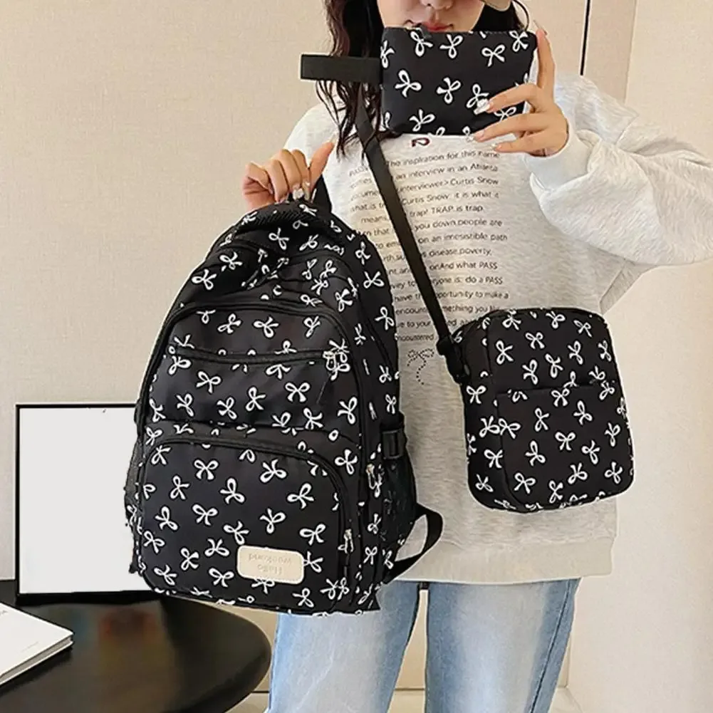 sac dos polyester motifs nœuds blancs fond noir beige deux petits sacs accessoires usage voyage école