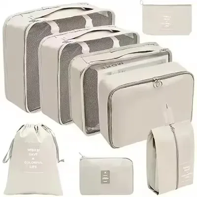 organisateur voyage polyester beige clair sac rangement vêtements chaussures sous-vêtements pochettes transparentes cubes modularité transport