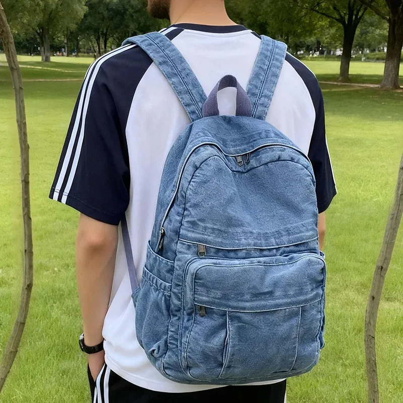 sac dos jean bleu denim cuir marron poche avant zippée bandoulières souplement détendu usage voyage école quotidien transport ordinateur portable