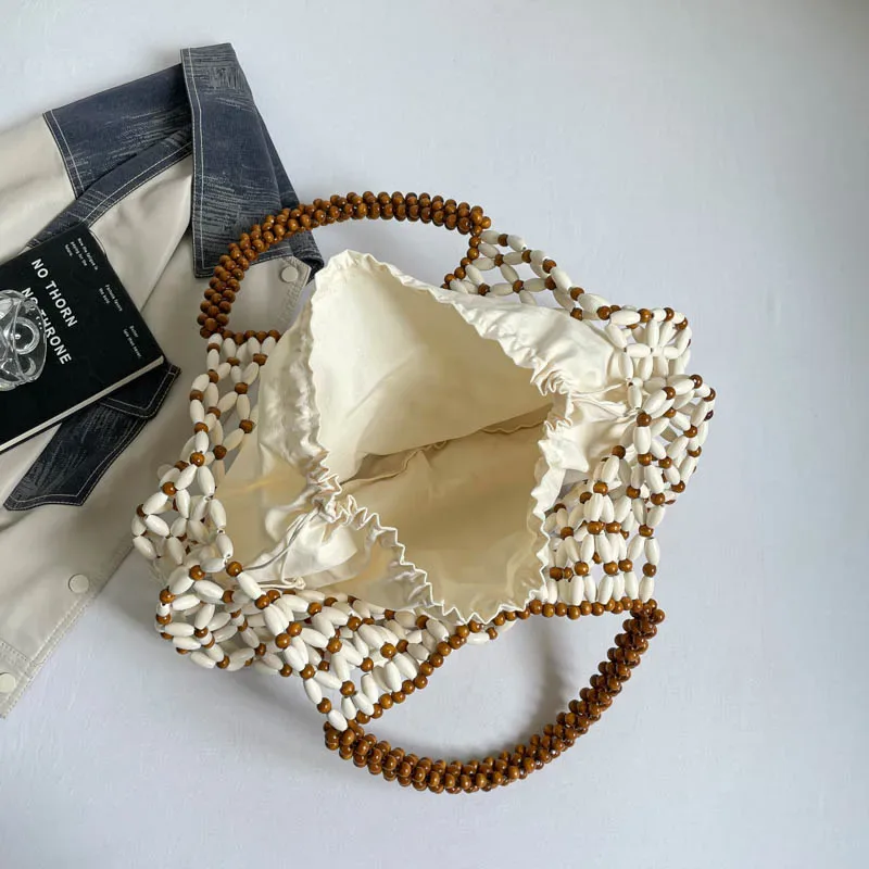 sac à main féminin fait main en perles, sac de plage tissé pour femmes, design exquis, sac seau creux en perles de bois, sac à bandoulière.