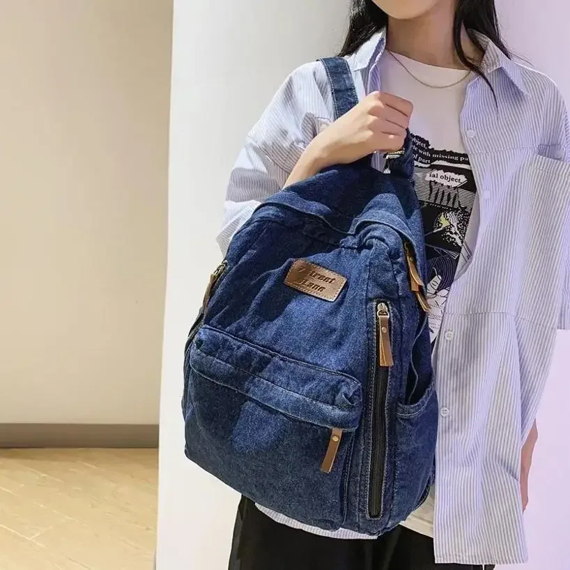 sac dos jean bleu denim poignée supérieure fermeture éclair compartiment intérieur usage étudiant voyage