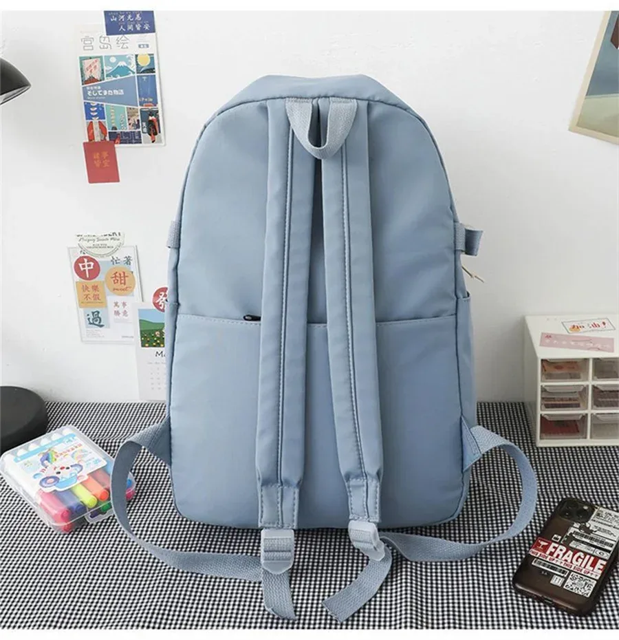 sac dos nylon animaux personnages beige noir poche avant appliques badge couverture souple ceinture air unisexe