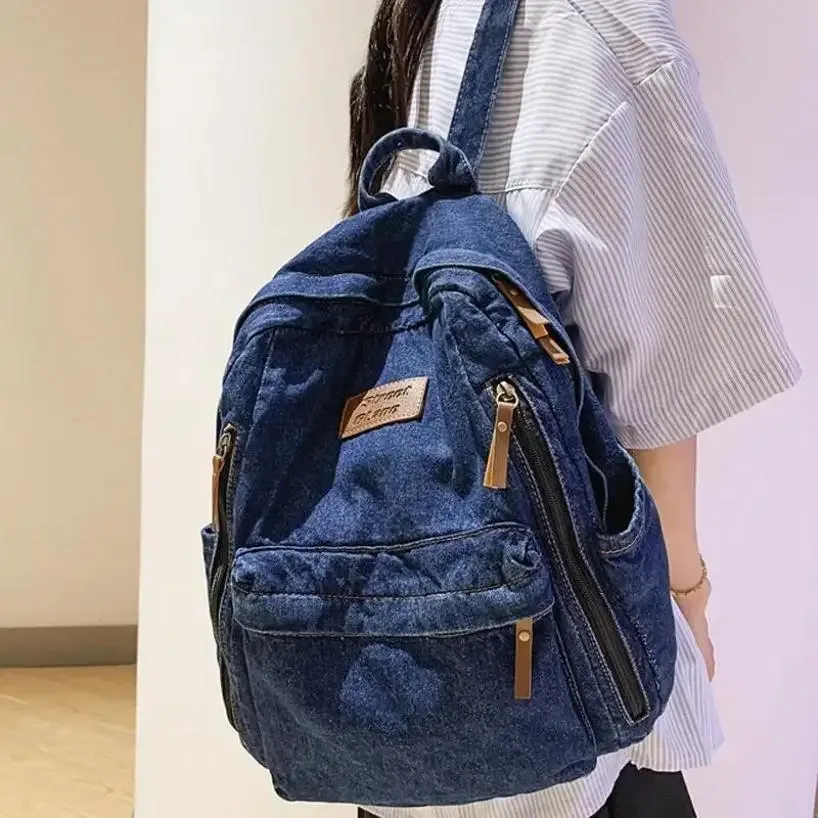 sac dos jean bleu denim poignée supérieure fermeture éclair compartiment intérieur usage étudiant voyage