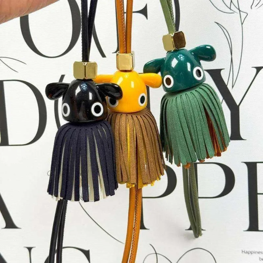 breloque de sac en cuir véritable avec grand œil et pompon, inspirée des créateurs de luxe, porte-clés à franges pour sacs à main, sacs à dos et accessoires de sac fourre-tout pour femmes