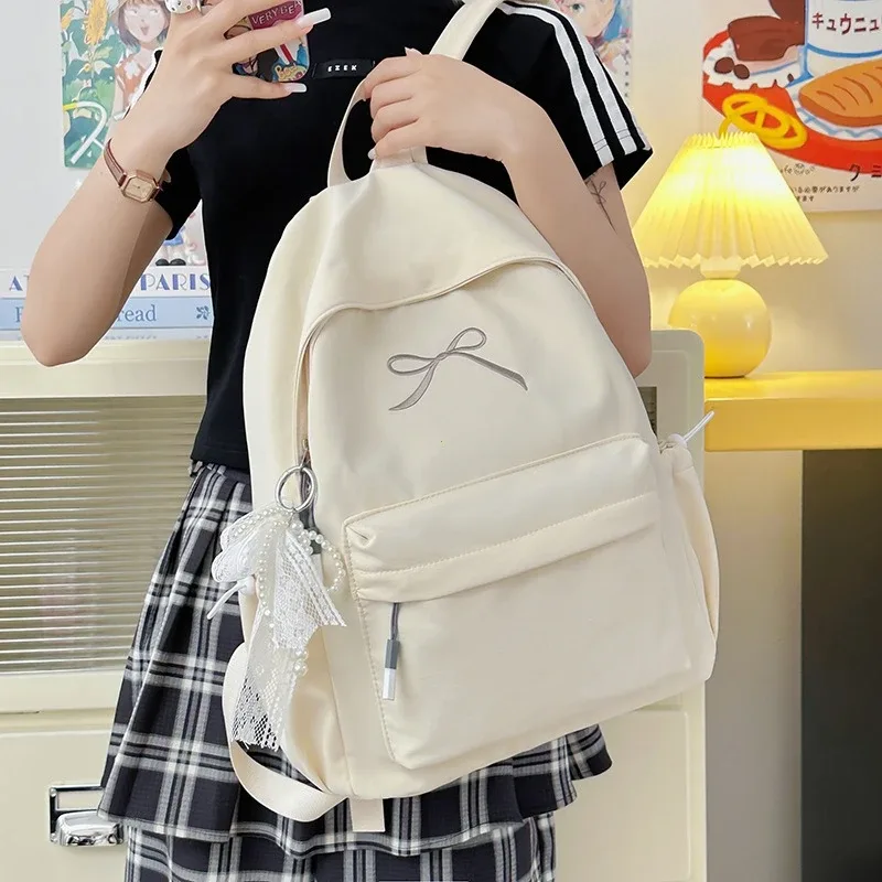 sac à dos portable brodé avec nœud pour filles, sac d'école en nylon de couleur unie pour étudiants, sac à dos de voyage léger de grande capacité pour femmes