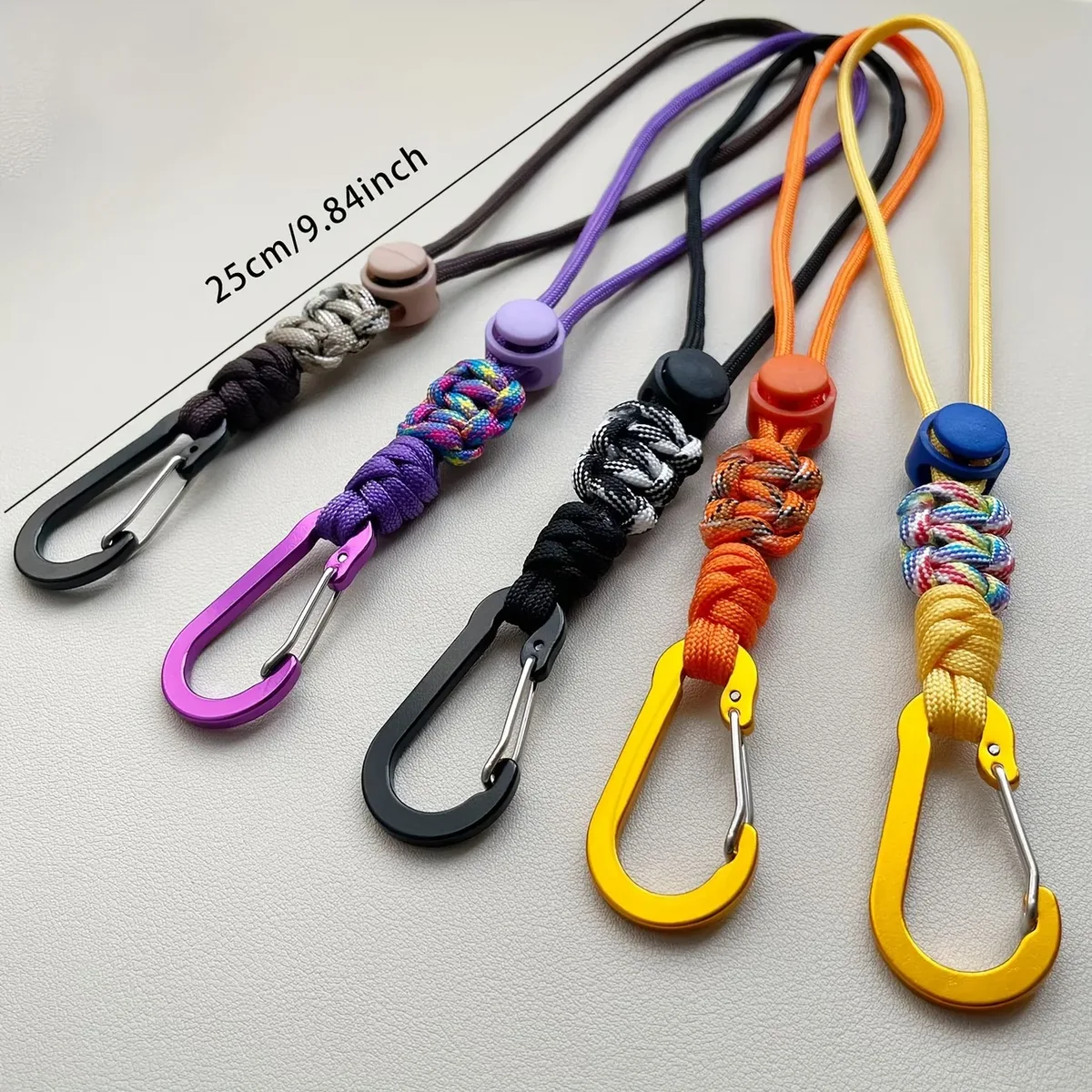 porte bouteille cordon paracord boucle métal nœud décoratif voyage randonnée jaune noir orange violet marron