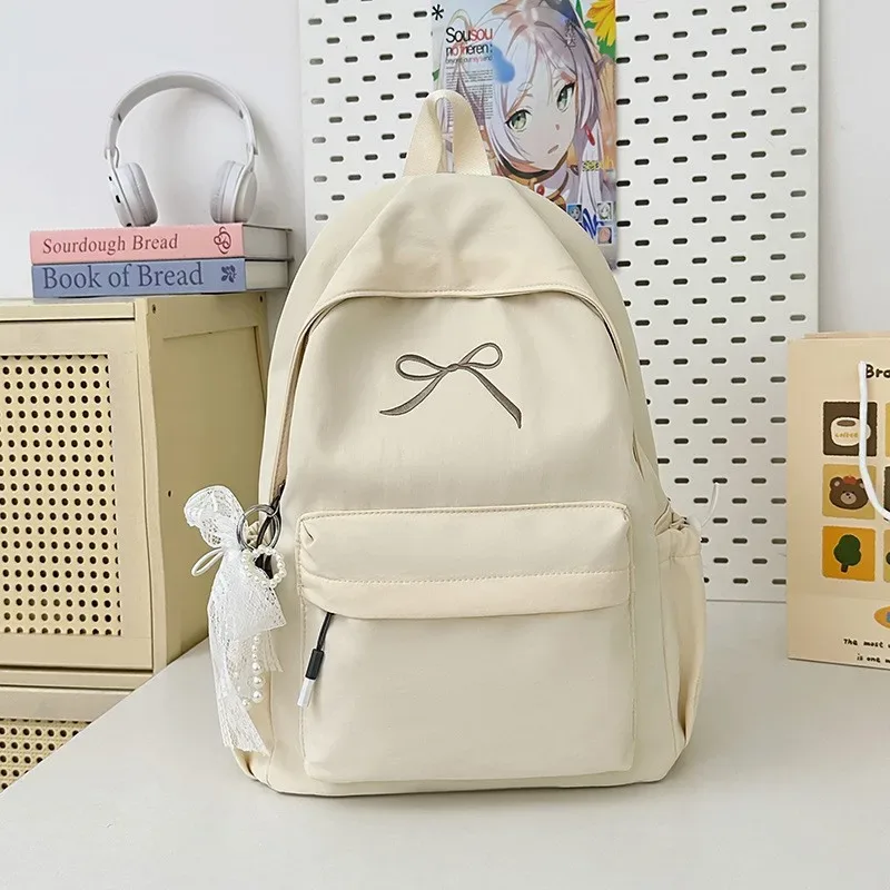 sac à dos portable brodé avec nœud pour filles, sac d'école en nylon de couleur unie pour étudiants, sac à dos de voyage léger de grande capacité pour femmes