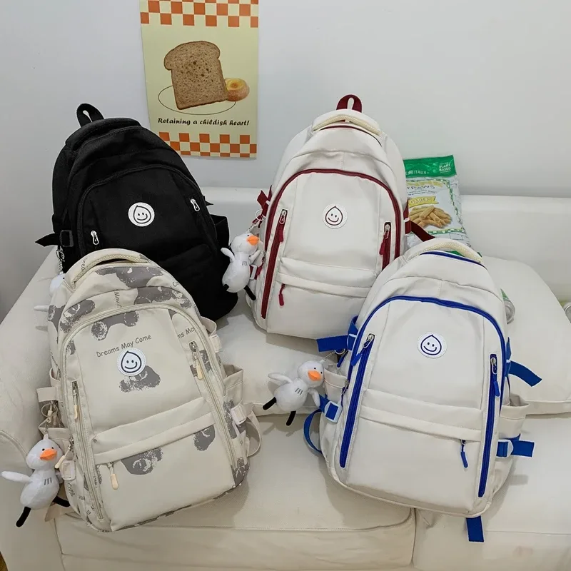 sac dos nylon blanc rouge bleu patchwork bandoulière arquée poche ouverte informatique classement souple voyager école collège