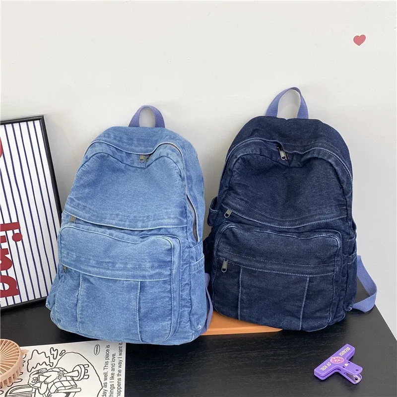 sac dos jean bleu denim cuir marron poche avant zippée bandoulières souplement détendu usage voyage école quotidien transport ordinateur portable