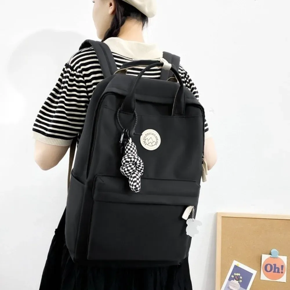 sac à dos imperméable pour femmes, en nylon, couleur unie, sac à dos de voyage ergonomique, grande capacité, sac pour ordinateur portable et livres, idéal pour les voyages d'affaires.