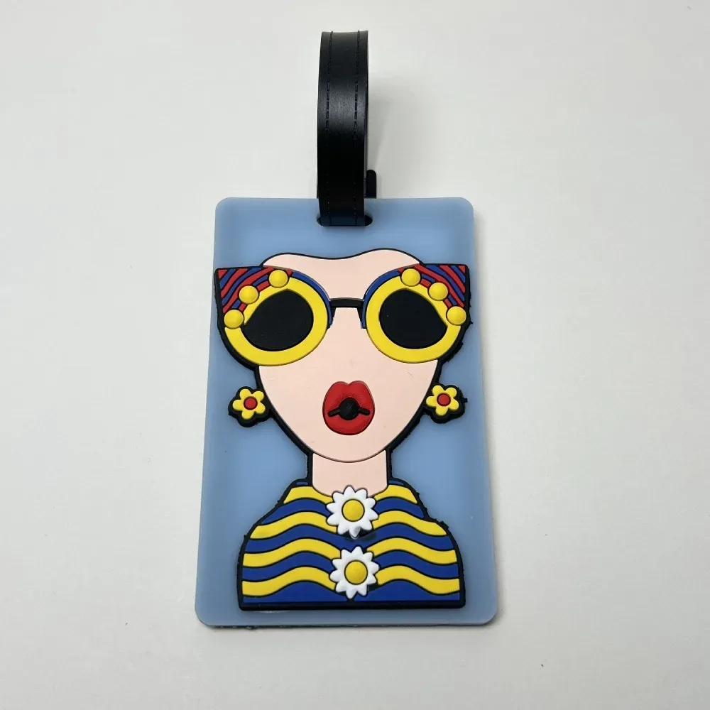 étiquette bagage caoutchouc visage lunettes fleurs géométrique bleu rose blanc voyage identification valise nom téléphone