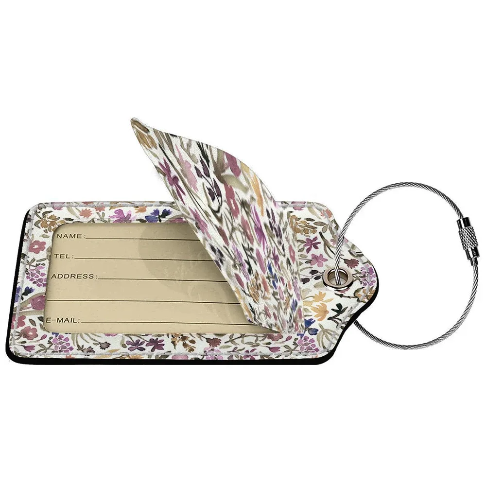 étiquette bagage polyuréthane motif floral subtil fond beige anneau métallique voyage affaires identification nom adresse