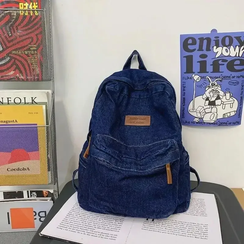 sac dos jean bleu denim poignée supérieure fermeture éclair compartiment intérieur usage étudiant voyage