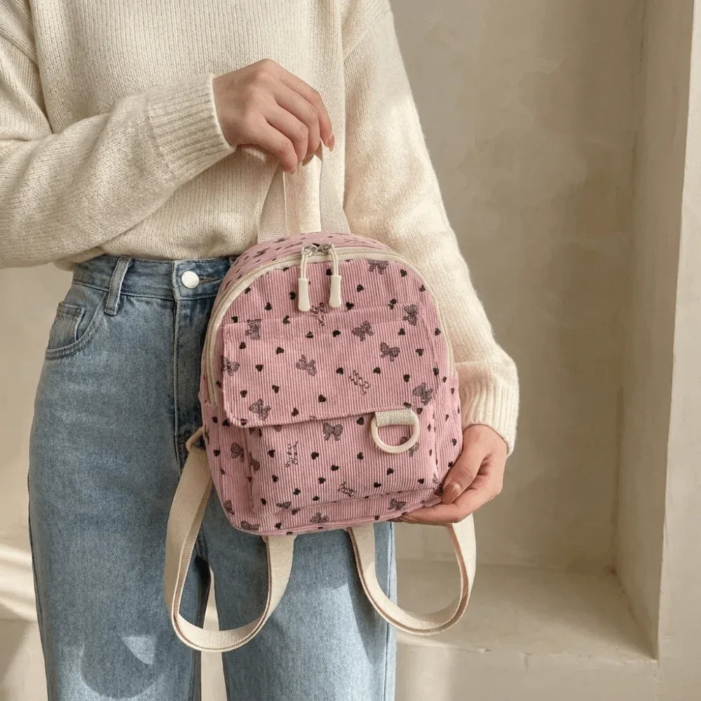 mini sac à dos en velours côtelé léger avec imprimé cœur et nœud, sac à dos décontracté multi-compartiments à ouverture zippée, sac à bandoulière de voyage