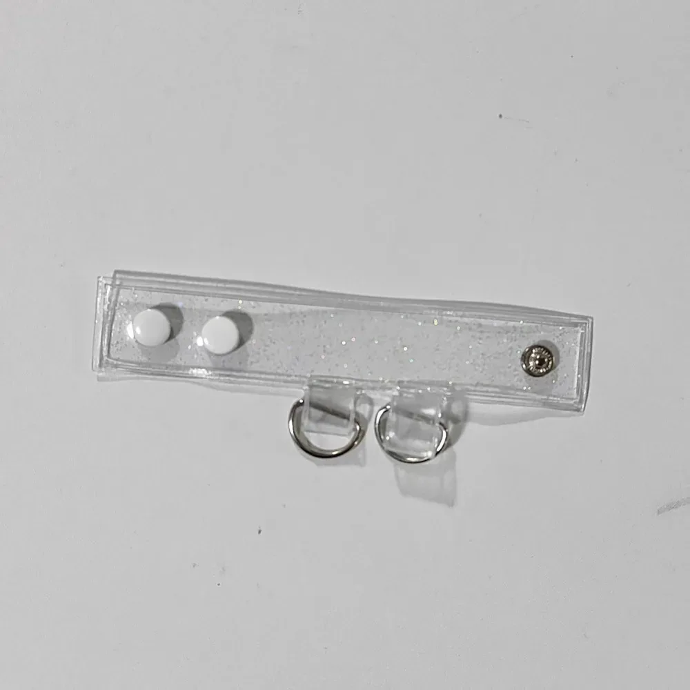 clip fixation sangle sac transparent anneaux métalliques boule centrale extension accessoires voyage polyvalent durables