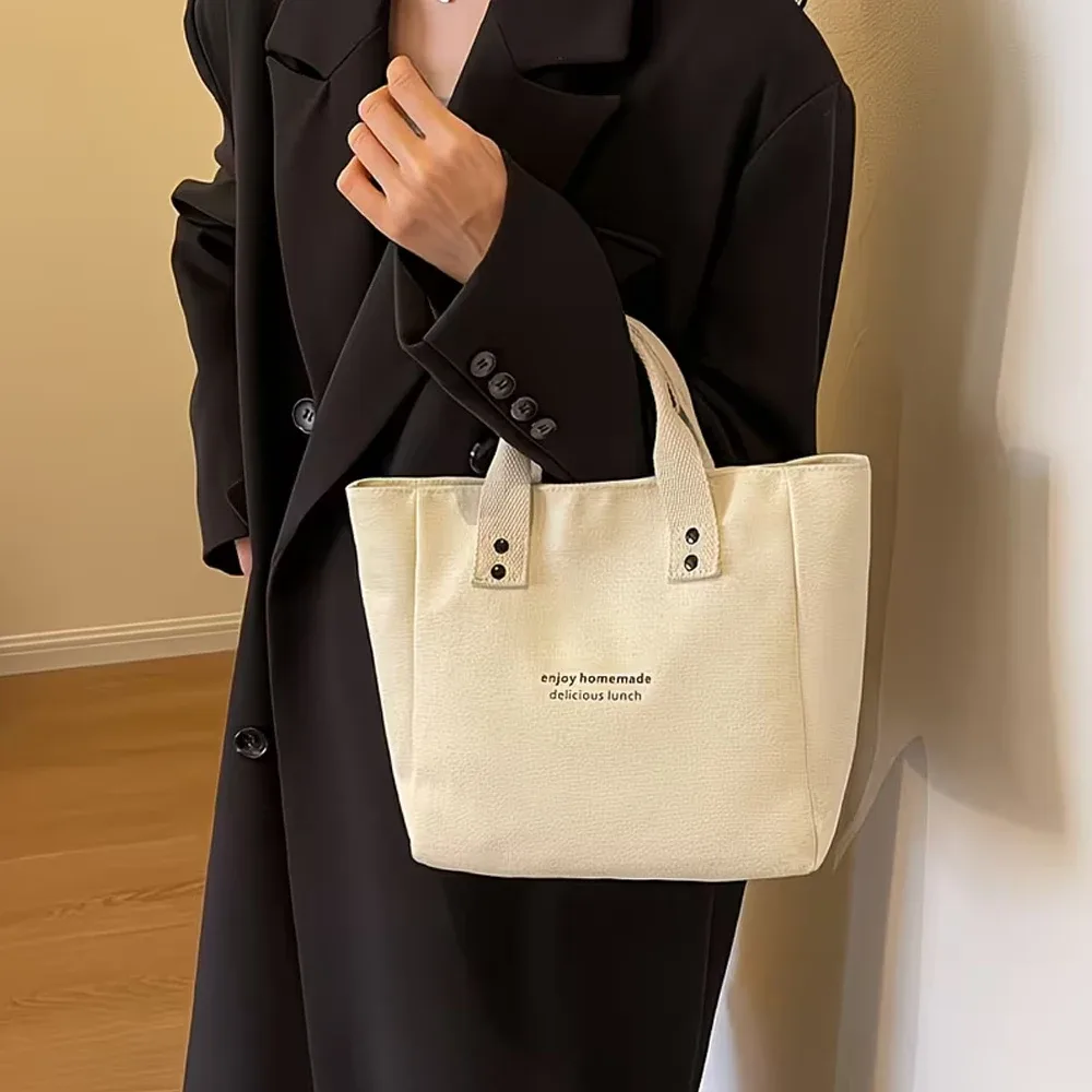 sac fourre-tout décontracté en toile avec pendentif cloche et fermeture éclair ; ce sac fourre-tout élégant et durable est parfait pour l'école et le travail