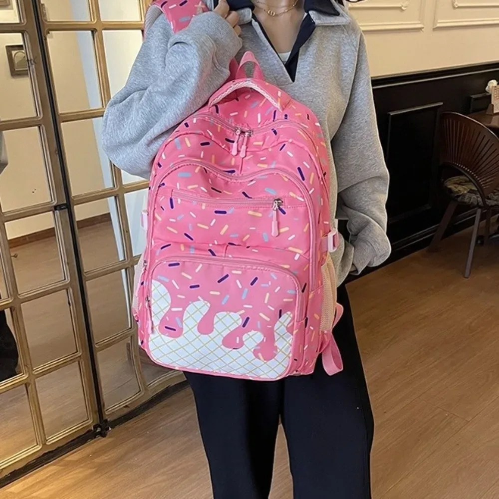 sac dos tissu oxford imprimé vanille perles colorées rose blanc format trapézoïdal fermeture glissière poche latérale maille usage étudiant voyage
