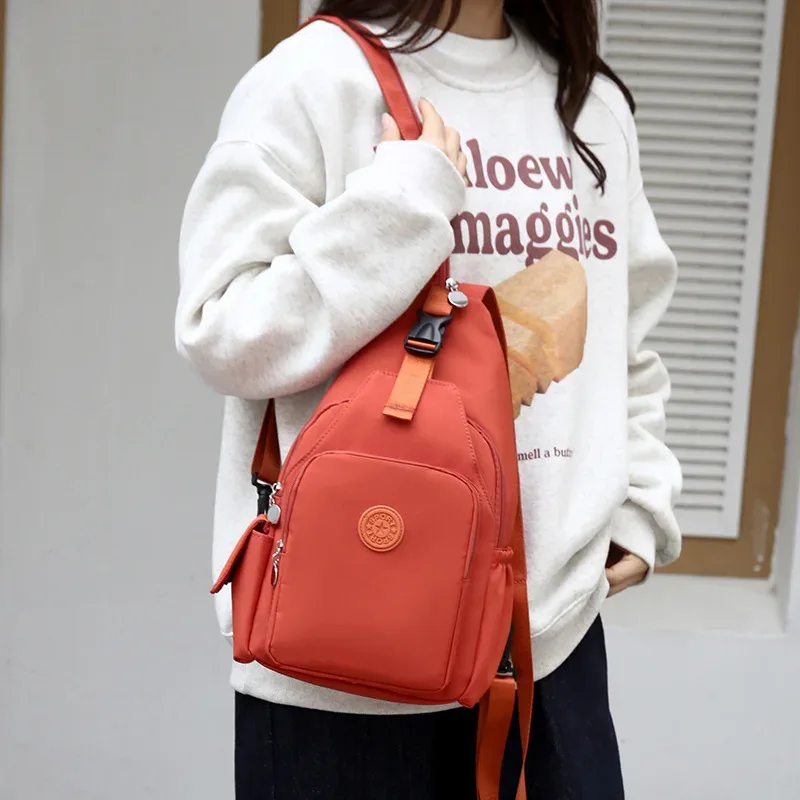 sac dos oxford tissu orange marron bandoulière arquée poignée rétractable loquet verrouillable intérieur chaussures bio coton capacité voyage