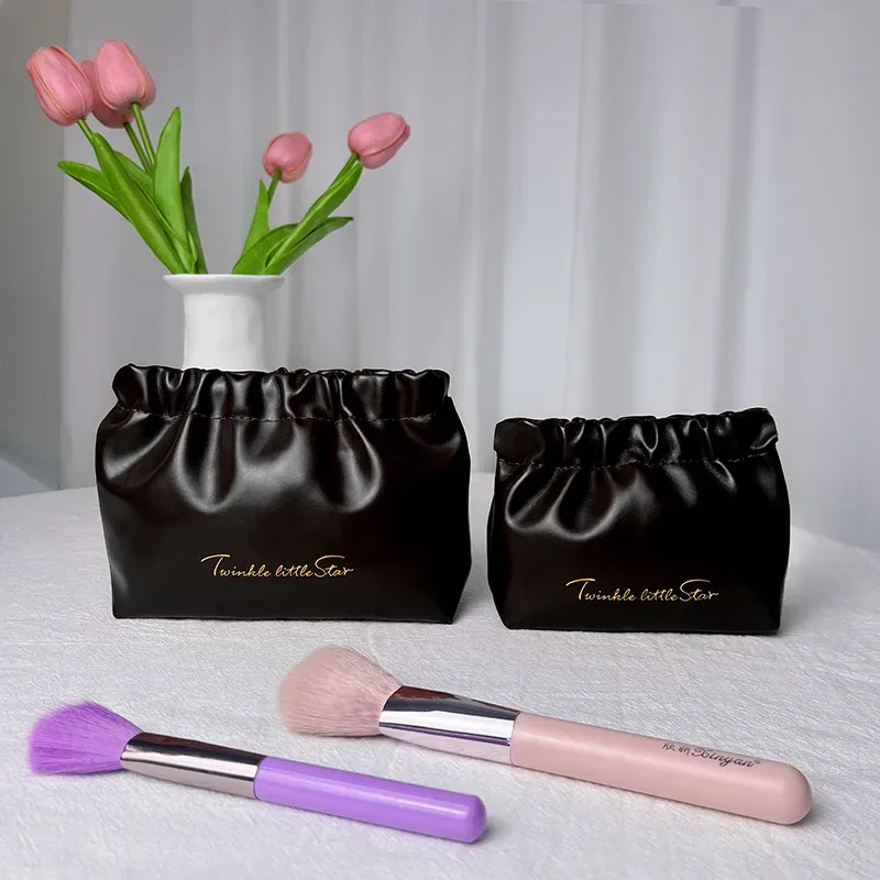 organisateur voyage cosmétiques pliables ovale ouvert motif plissé couleur bleu noir beige femme maquillage chauffereuse